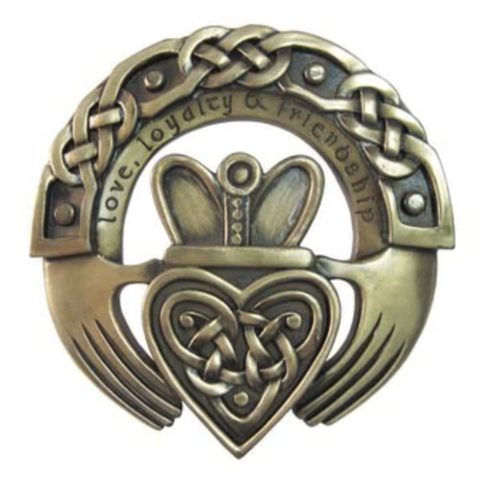 A picture of the claddagh symbol on a pin.